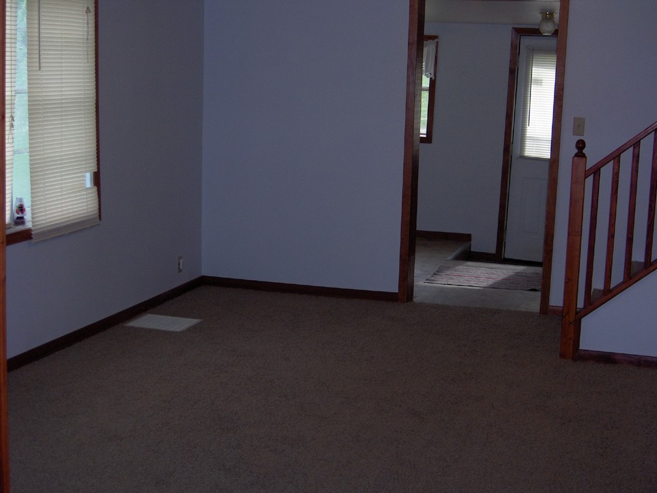 living room new carpet.  front entry with main floor laundry.