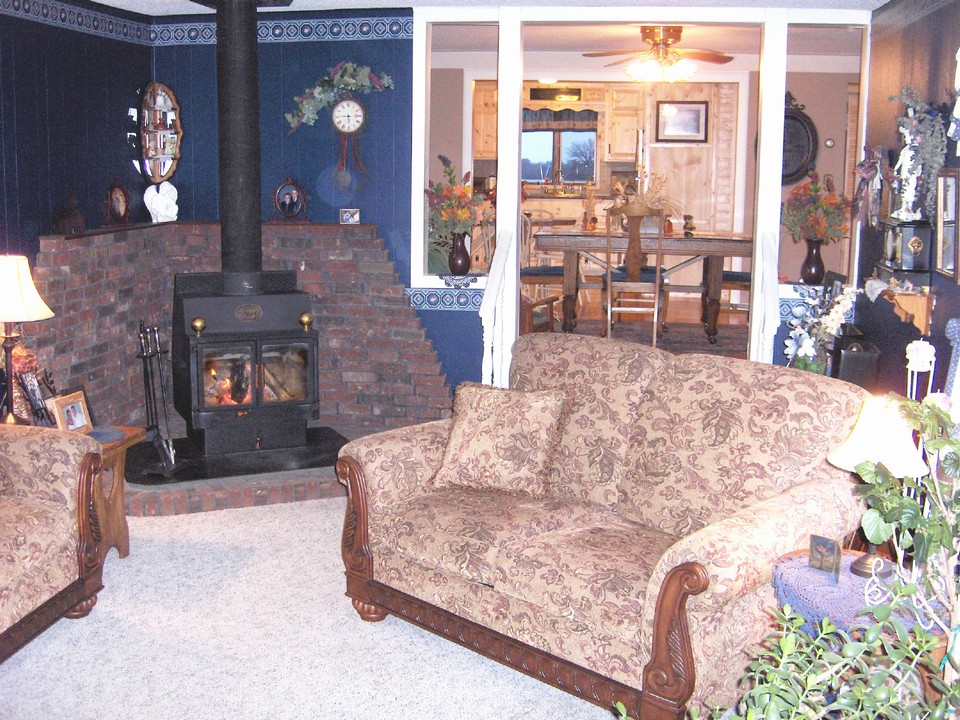 living room wood burning fireplace.  open to the dining room and kitchen.