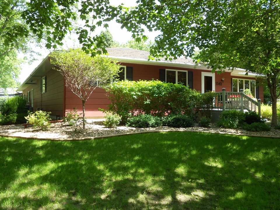 front of home nice landscaping, bushes, trees, and flowers.  permanent decking off of front door.  underground sprinkler system for water.  painted in 2011.  gutters have a guard over them.
