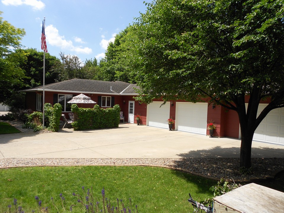 driveway, patio, and garages nice privacy fence, flagpole, landscaping