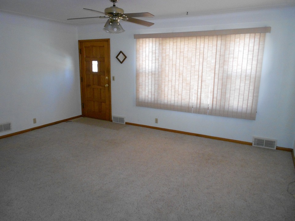 nice sized living room with big windows