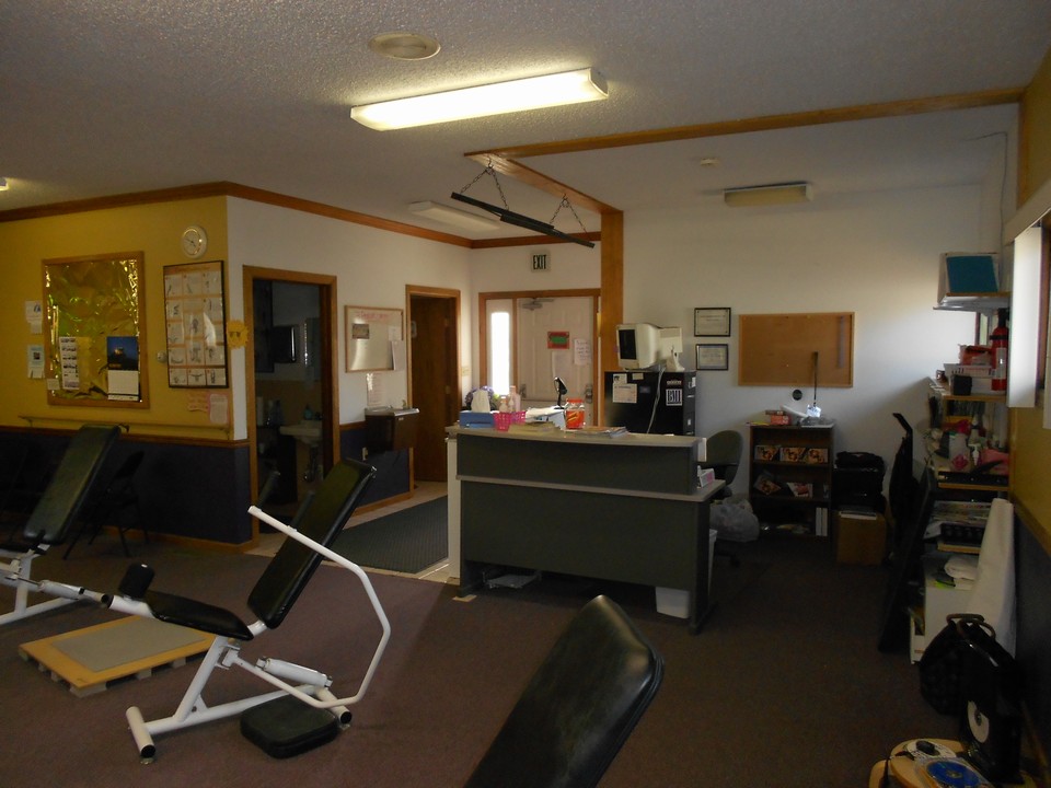 interior shows office space and 2 bathroom entries