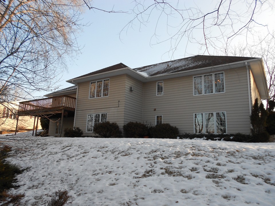 rear of home large windows and 2 walk out decks/patios