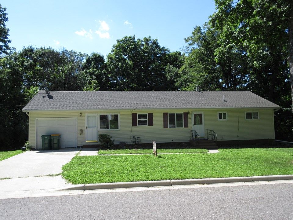 front of home modern shingles, windows, siding, and landscaping