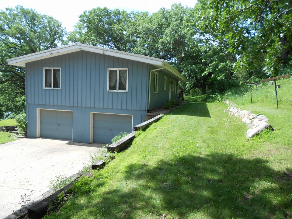 side and back of home new landscaping and 2 car garage.