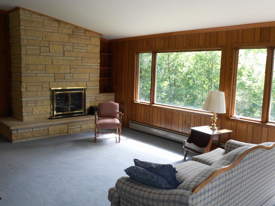main floor living room big windows and fireplace.