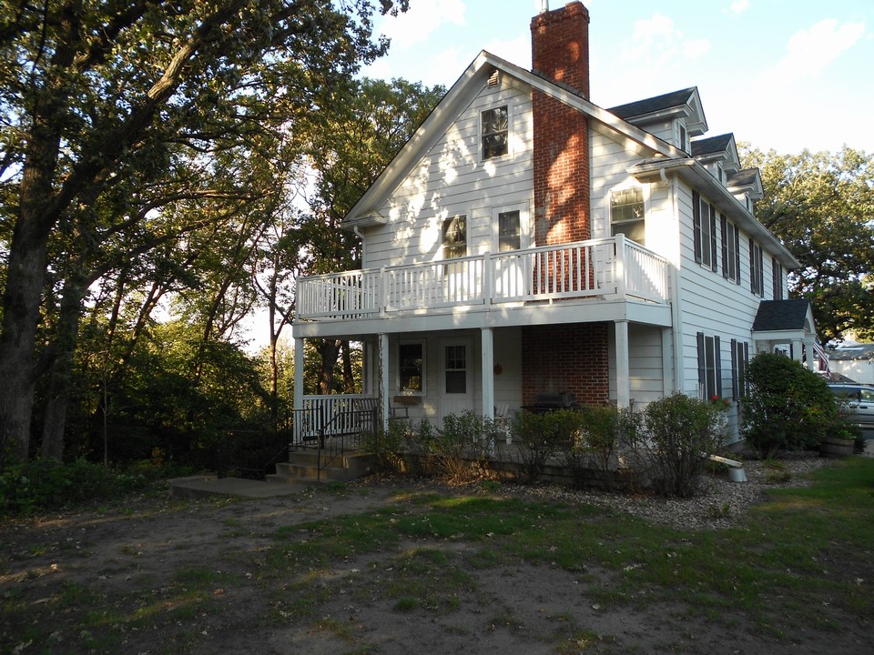 side of house upper balcony and lower covered patio.