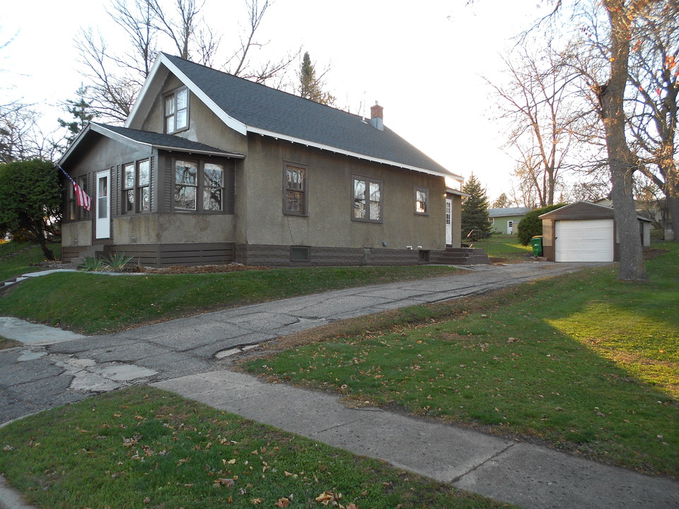 side of home driveway, garage, nice backyard