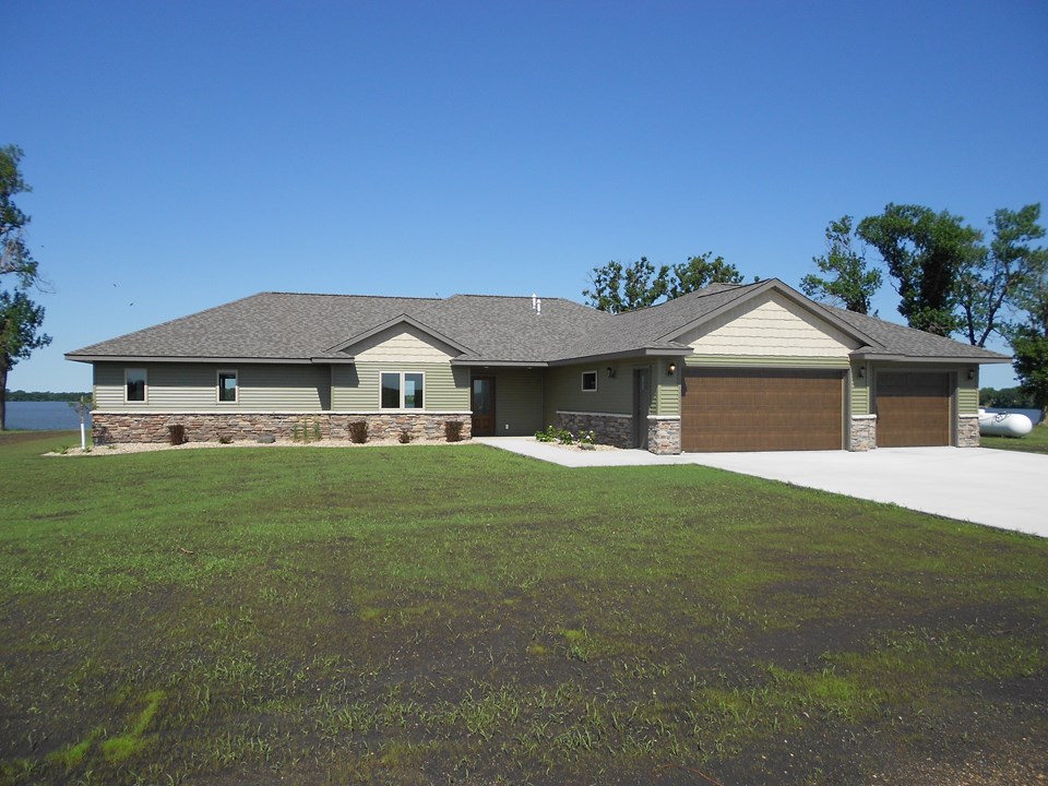 front of home multiple types of siding and roof lines give the home great curb appeal.