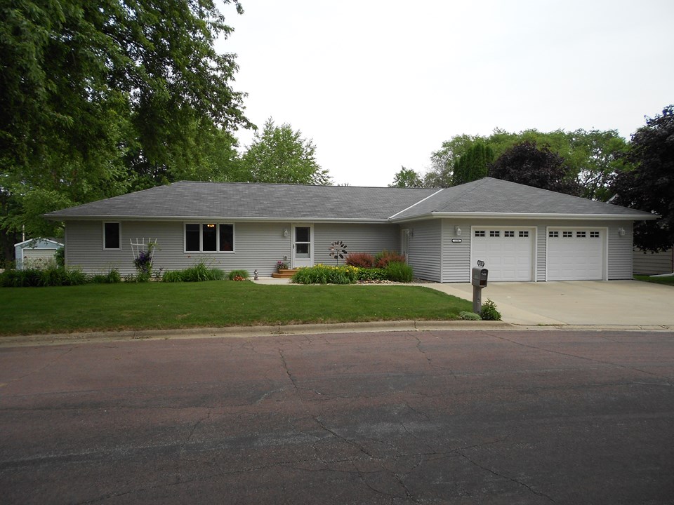 front of home very nice curb appeal with a good roof, siding, windows, and landscaping.  4 car attached garage.