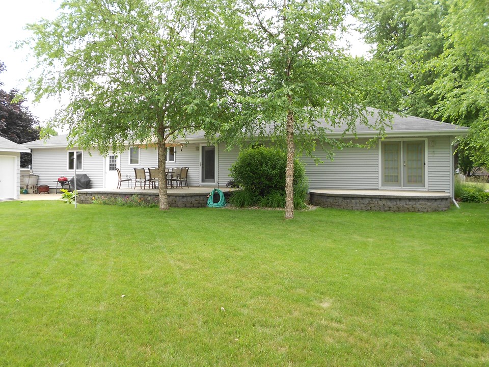 back of home two separate patios, one off of kitchen and one off of master bedroom. a very nice private backyard.