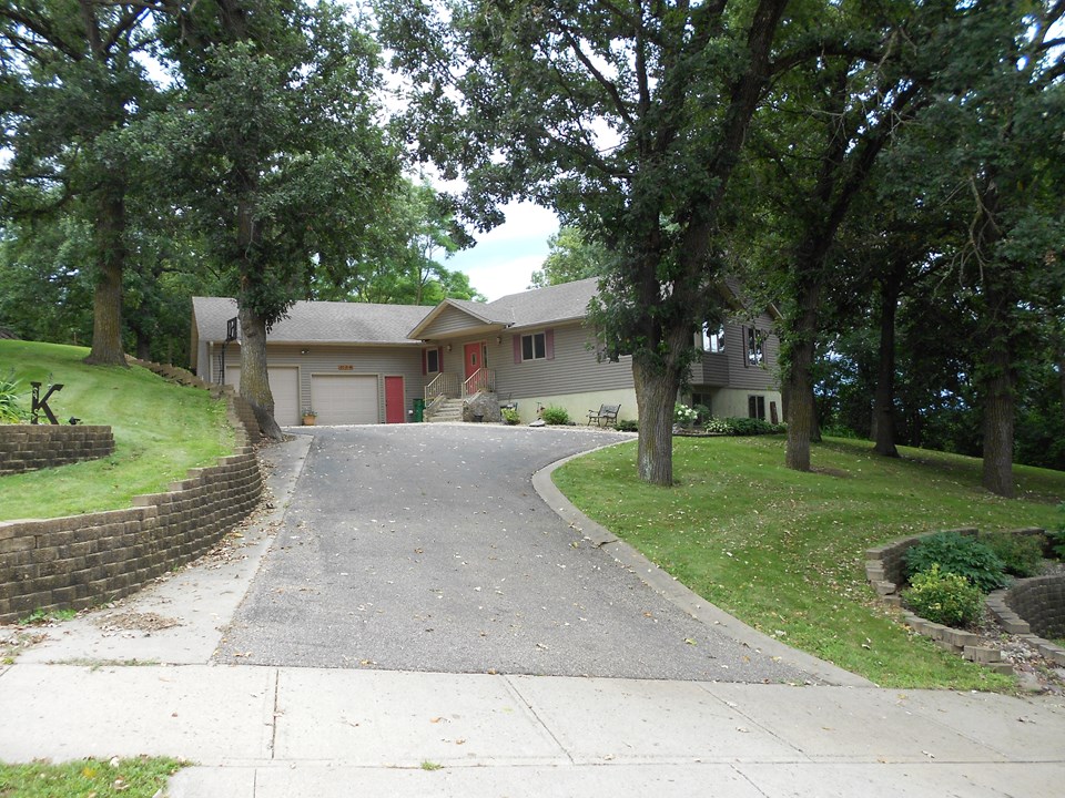 front again nice front yard and lots of landscaping with full grown trees.