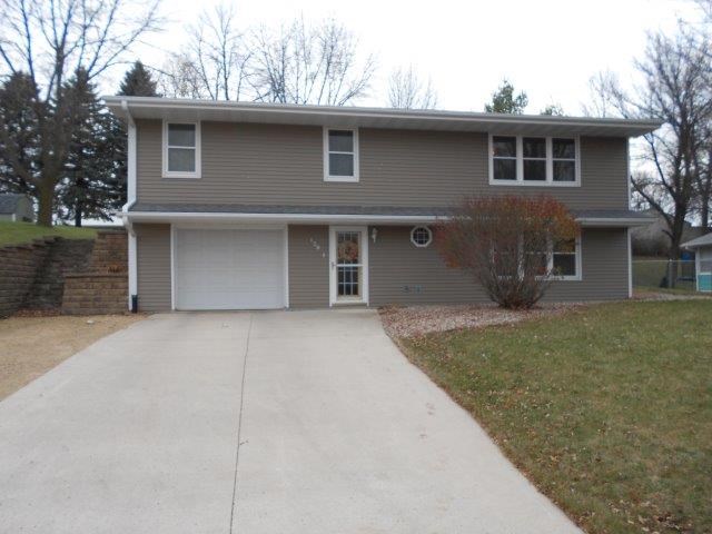 front of home new landscaping, driveway, roof, gutters, siding, and windows give this home great curb appeal