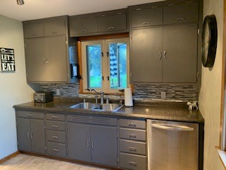 kitchen newer floor, countertop and backsplash, newly painted cabinets, dishwasher