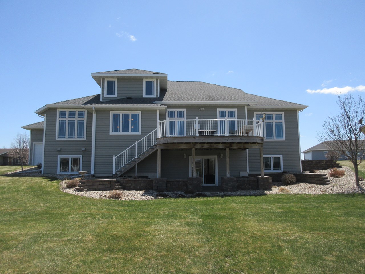 back of home permanent decking.  walk out basement.  very nicely landscaped.  many new windows.