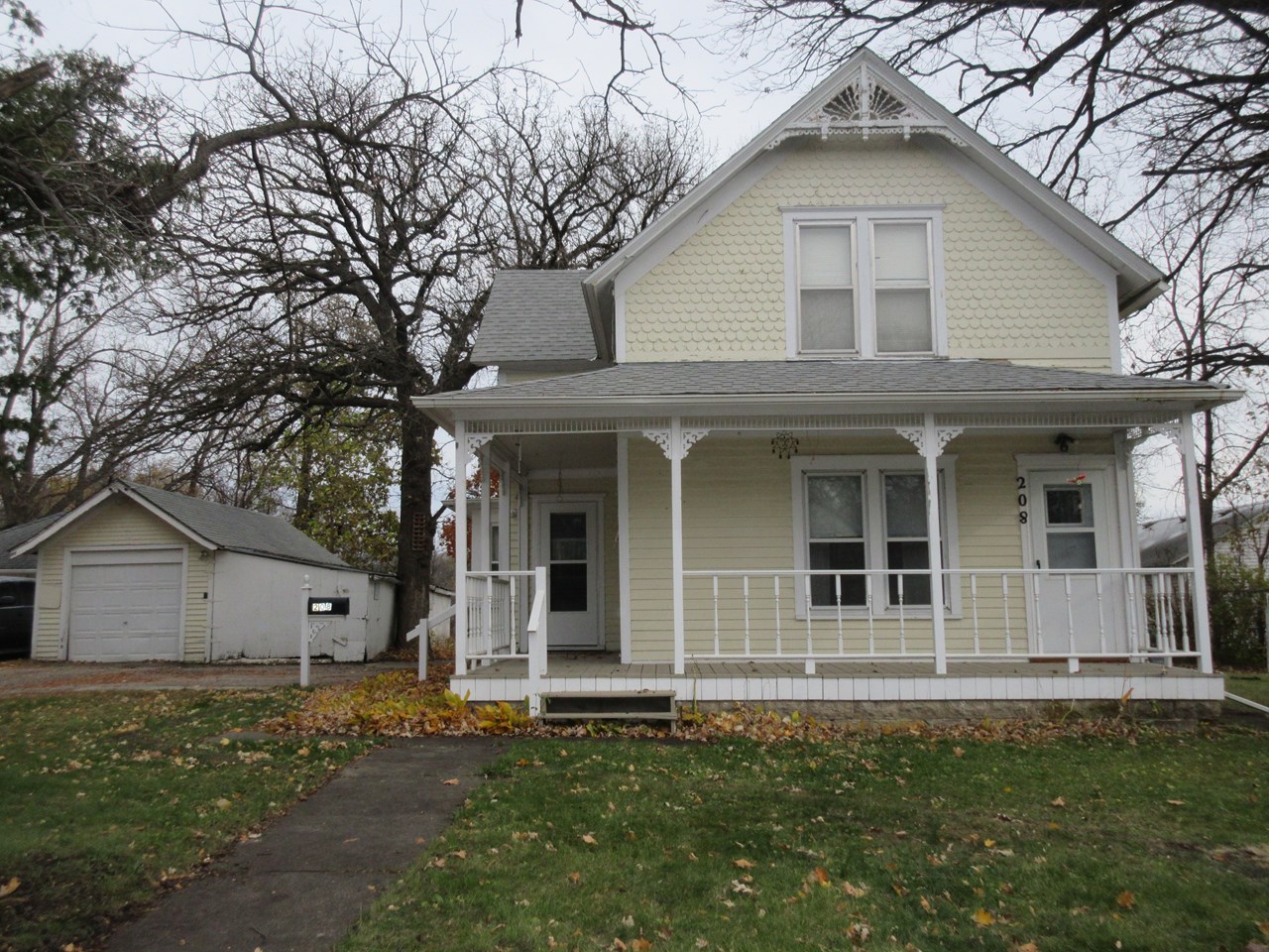 front of house open porch and single garage