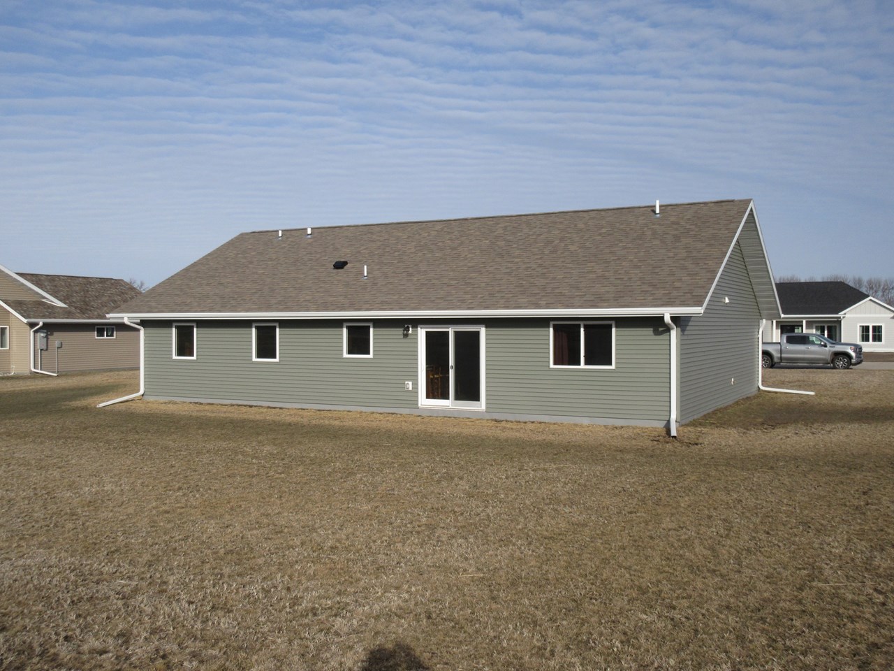 large flat backyard patio doors to the backyard, with access to the walking trail.