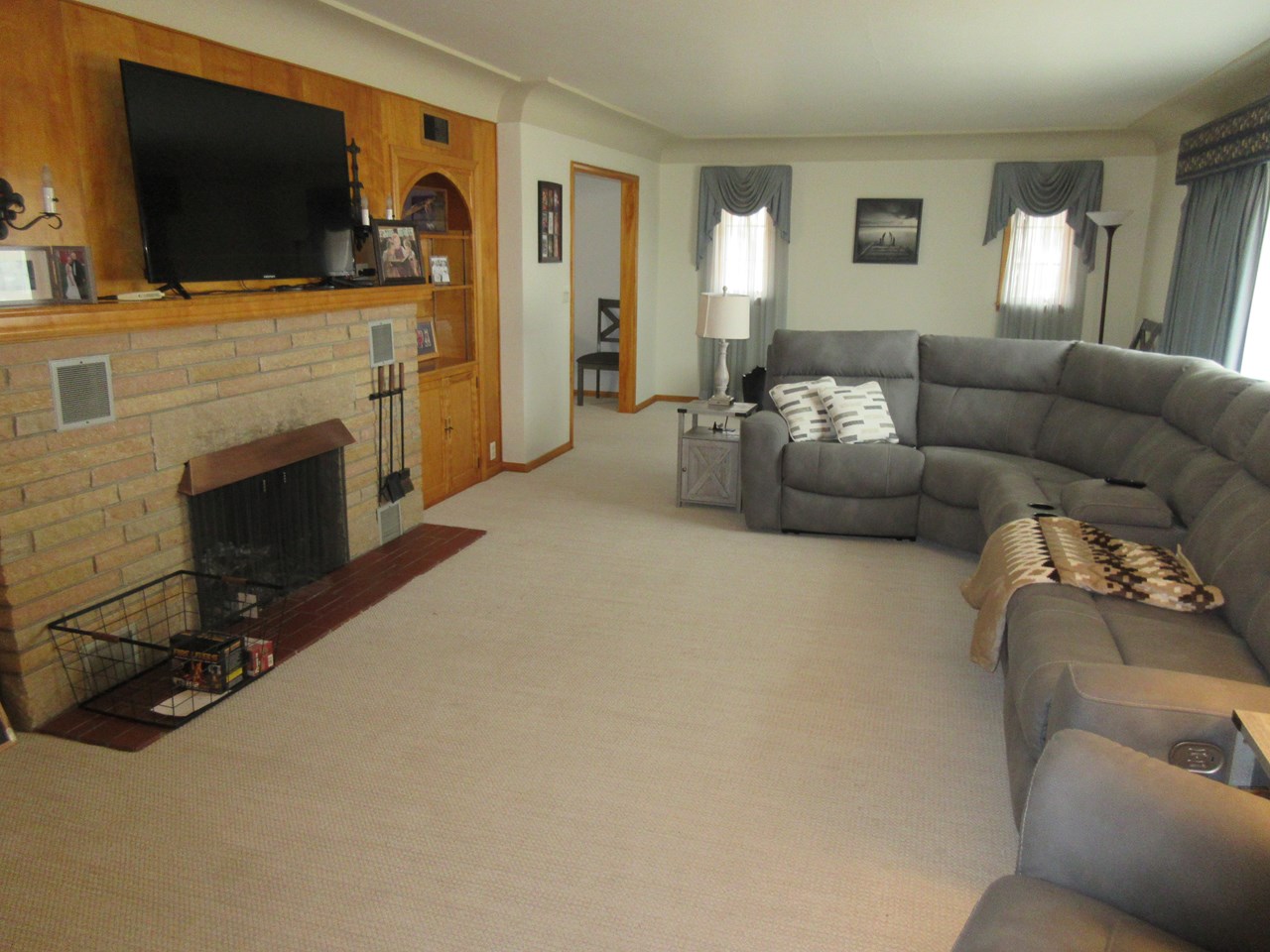 living room with fireplace and coved ceilings