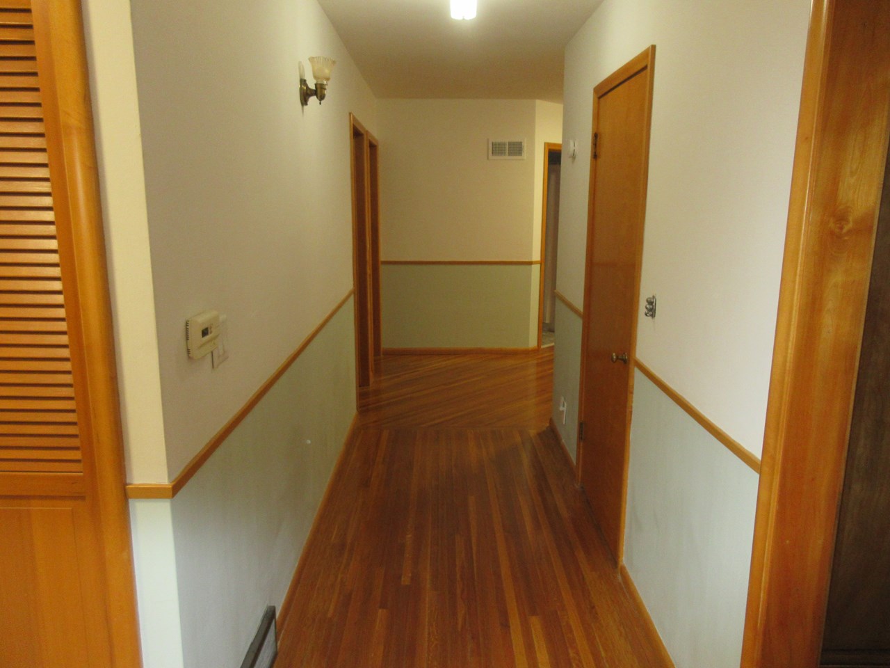 very wide hallway with hardwood floors